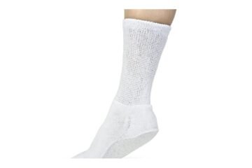 Diabetic crew socks on white linen with glucose meter and aloe plant