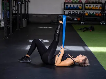 A person performing a controlled bicep curl using a light stretch band.